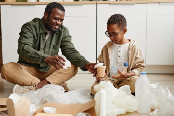 Father and children recycling different types of plastic containers